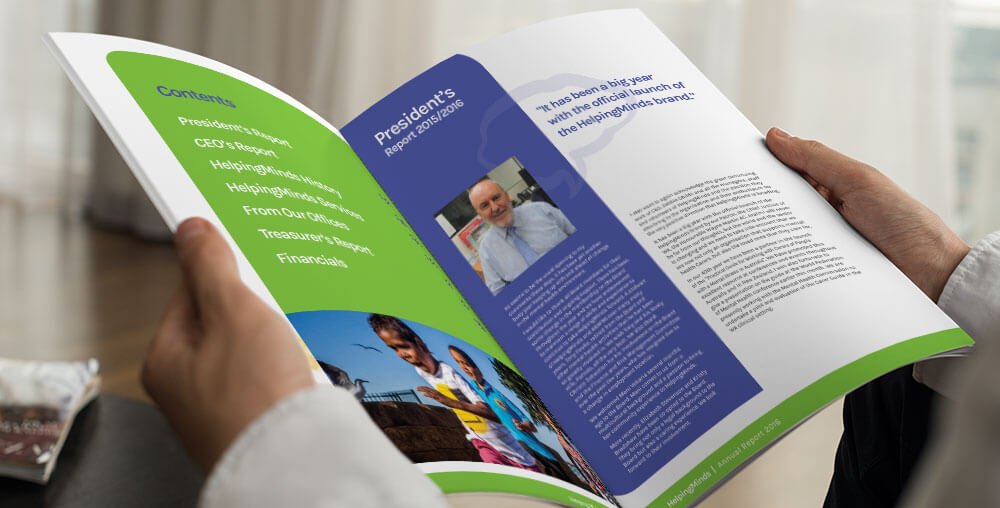 Man reading HelpingMinds' Annual Report brochure which can be downloaded online