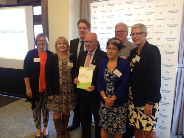 HelpingMinds family posing with Mental Health prize awardee
